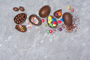 Chocolate traditional easter eggs with bright colorful dragee and sugar sprinkles or confetti