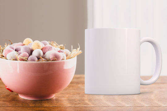 White Mug Mockup - Easter theme. Pretty pink bowl with mini chocolate eggs in, next to a white coffee mug. Perfect for businesses selling mugs, just overlay your quote or design on to the image.