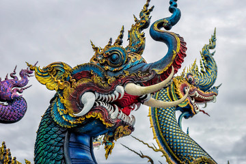 Fototapeta na wymiar Beautiful blue naga sculptureat the public temple, Wat Rong Sua Ten