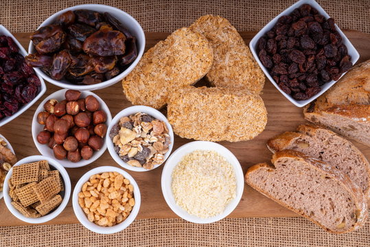 Healthy Breakfast Foods.  Variety of Breakfast cereals with nuts, dried fruits and wholemeal bread. - Powered by Adobe