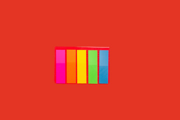 set of sticky notes lying on red background. concept of office stationary