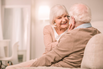 Attractive senior woman sitting close to her partner