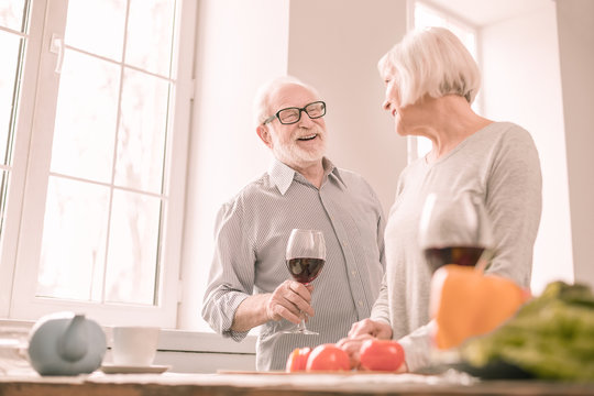 Positive delighted male person going to taste wine - Powered by Adobe