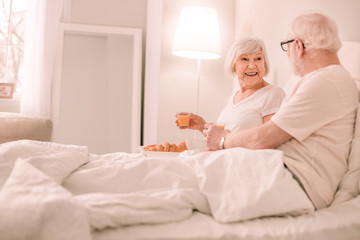 Obraz na płótnie Canvas Amazing mature woman having breakfast in bed