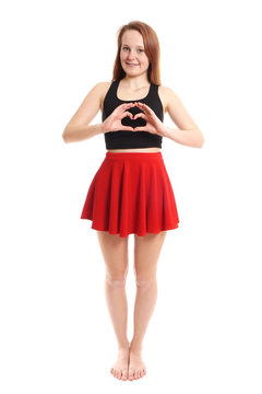 full length young woman making heart shape with her hands                               