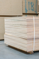 timber in warehouse. Pallet with boards in the hardware store. Packed boards in the building store. building materials. warehouse with variety of timber for construction and repair. vertical photo.