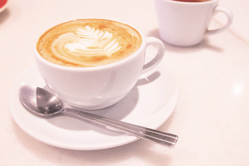 White cup with beautiful latte art coffee. Morning. Refreshing concept