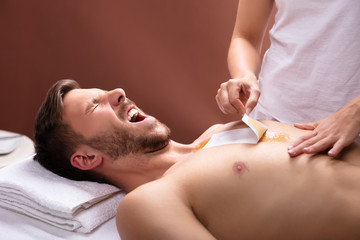 Man Screaming While Waxing Chest
