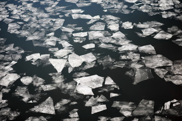 Drifting on the river. Fragments of ice float on river.