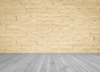 Grunge brick wall painted in light yellow beige with wooden floor in grey for interior backgrounds