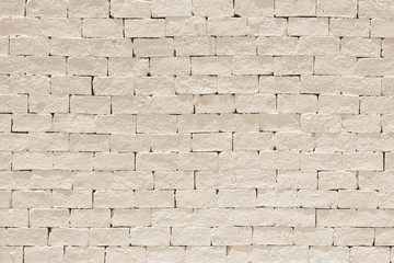 Old aged rough brick wall texture background painted in light sepia color in grunge style