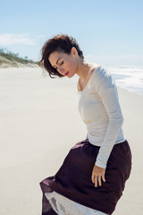 Portrait of brunette woman near the sea in motion