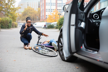Woman Calling For Help Near Unconscious Cyclist Lying On Street
