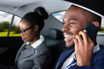Businessman Sitting Inside Car Talking On Cellphone