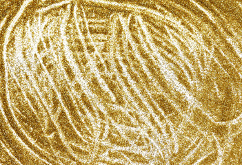Closeup of golden glitter dust spread on paper