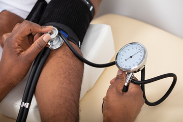 Doctor Measuring Blood Pressure Of Patient
