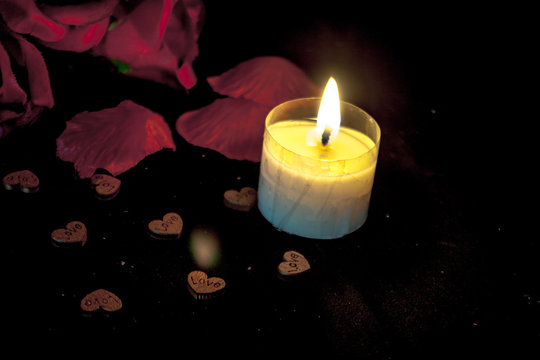 Photoshoot of petals rose and candle burning for decoration Valentine