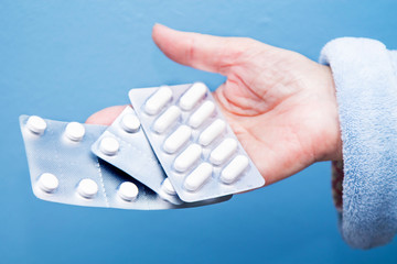 hand holding tablet of pills