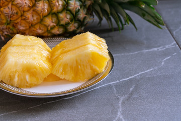 Whole pineapple and pieces of pineapple.