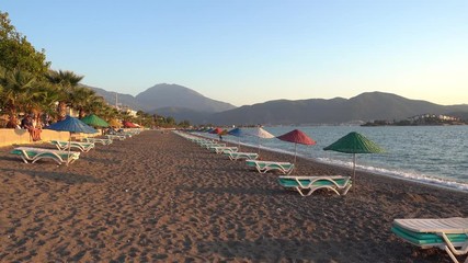Calis Beach, Fethiye, Turkey - 16th of October 2017: 4K Empty sandy beach before sunset, colors and shadows