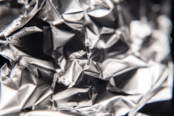 Silver foil closeup texture. Black and white abstract background. Foil crumpled.