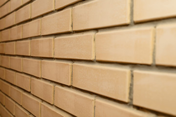 brick wall of light brown facing bricks on the side