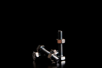 Screw-bolts and female screws on black background