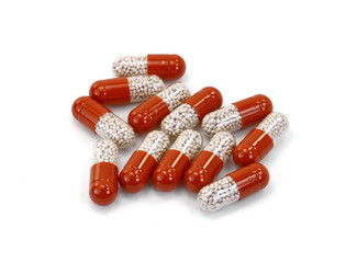 Red transparent capsule isolated on white background.