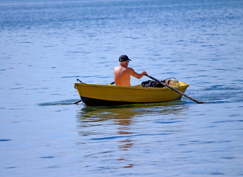 Man rowing a row boat