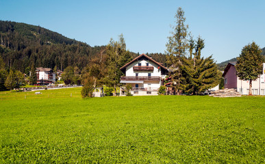 Fototapeta premium Village of Gosau with its wooden houses in the Alps of Austria on a sunny day.