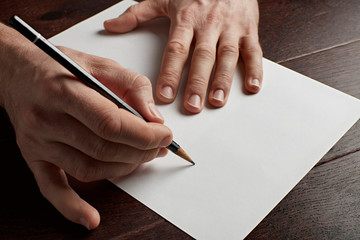 A person draws or writes on a piece of paper. - 244167212