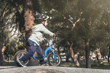 Kid riding his balance bike
