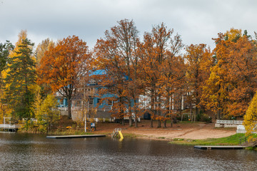 Fototapeta na wymiar Houses on the shore of the lake ar fall season. Nelijarve, Estonia.