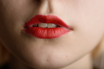 Fototapeta premium Beautiful female lips with red lipstick.