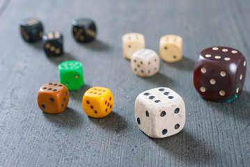 used dices with six dots on aged wooden background