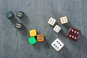 used dices with six dots on aged wooden background