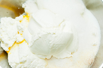 whipped cream topped dessert ingredients in metal mixing bowl