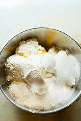 whipped cream topped dessert ingredients in metal mixing bowl