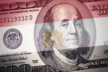 Obraz na płótnie Canvas flag of egypt on a american dollar money background