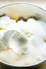 whipped cream topped dessert ingredients in metal mixing bowl