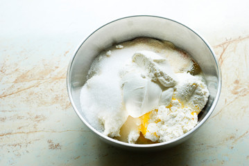 whipped cream topped dessert ingredients in metal mixing bowl