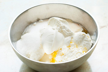whipped cream topped dessert ingredients in metal mixing bowl