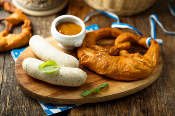 Traditional German pretzel with white sausage and mustard