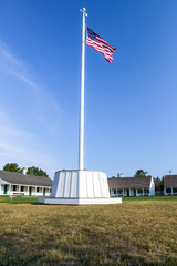 Fototapeta premium Historic Fort. American flag and canon at Fort Wilkins State Historic Park is a remote military outpost in the Upper Peninsula of Michigan.