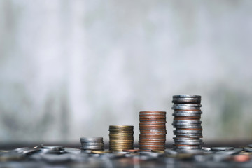 Save money concept with coin stack growing business on abstract background