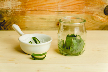 slices of fresh aloe on a calm, rustic, wooden background