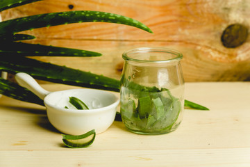 slices of fresh aloe on a calm, rustic, wooden background