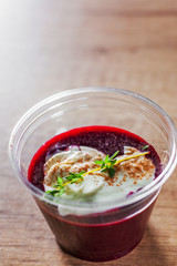 Summer fresh cold dessert berry soup with yogurt in a plastic cup