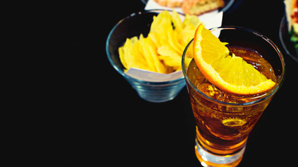 cocktail and chips isolated on black background with copy space 