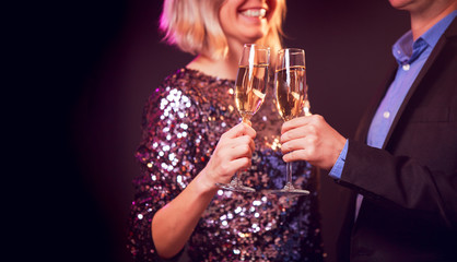 Image of happy couple with champagne glasses with champagne on black background